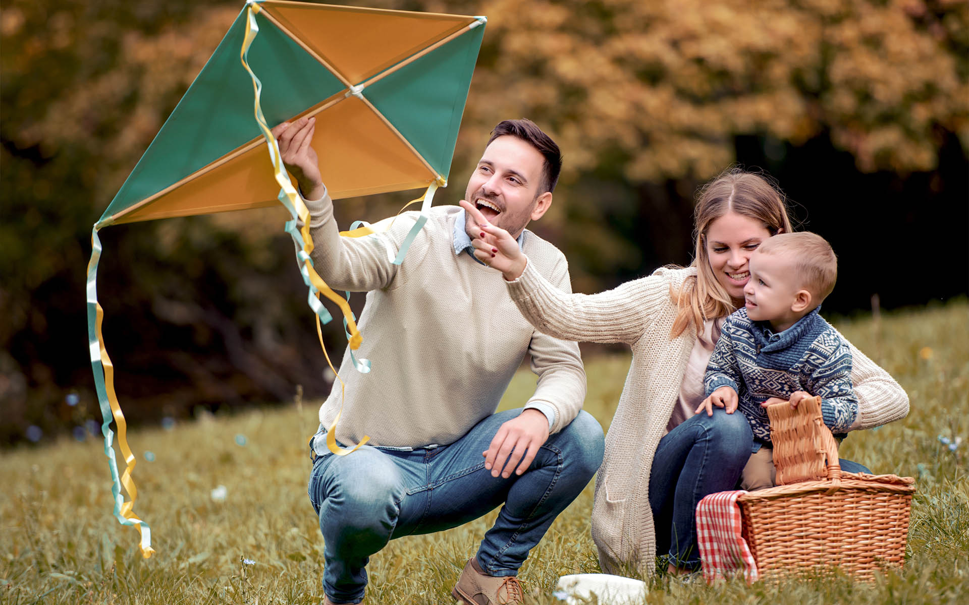 Homepage - Young Family Flying Kites Outside at the Park During Autumn